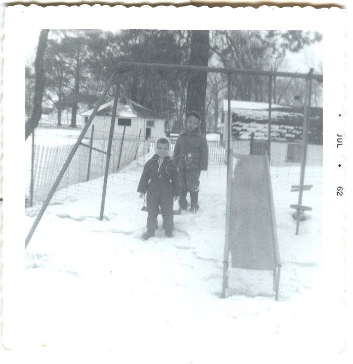 0560 (1).jpg - Lamar Roth & unknown.  Swinging in the snow. 1962